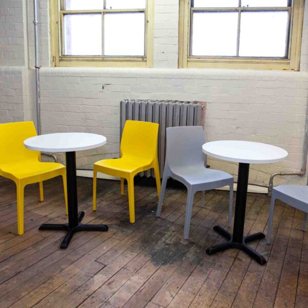 "Tuff-Top-White-600-Round-Table-tops-on-a-Phoenix-Base-with-Strata-Yellow-and-Grey-Side-Chairs.jpg"